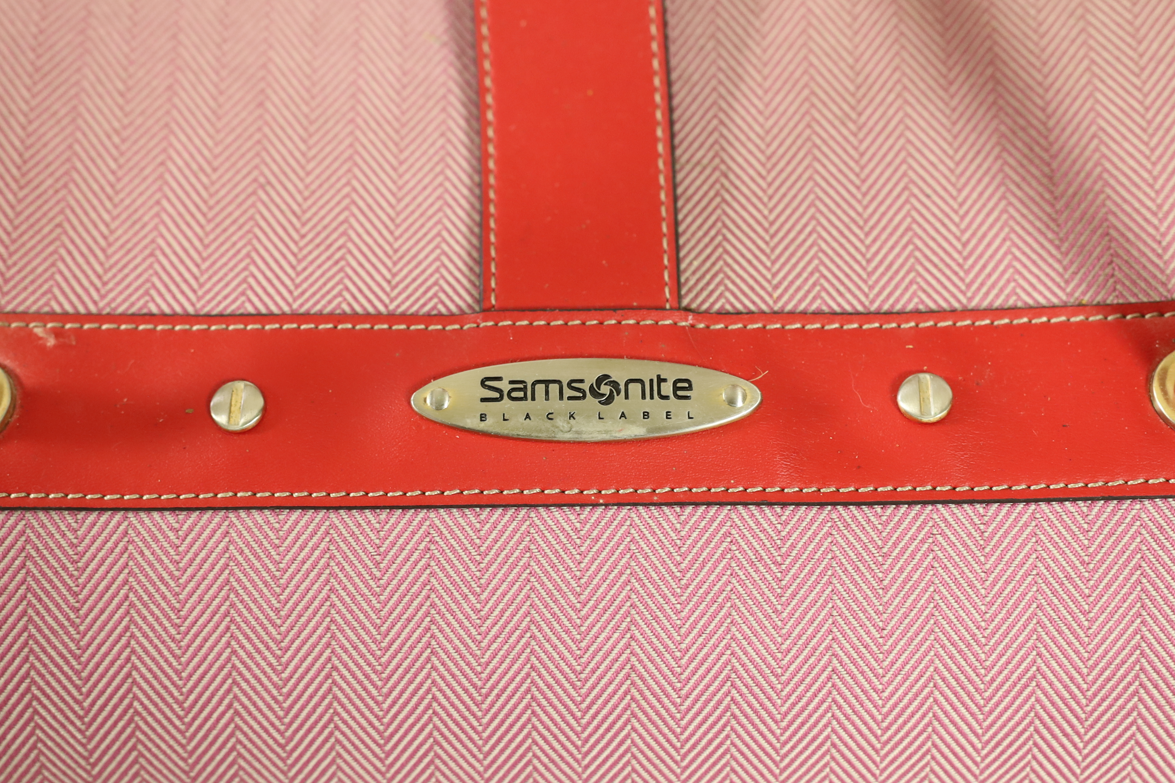 Three pink Samsonite Black Label luggage bags, Hard suitcase height 76cm, width 47cm, depth 31cm, Large holdall height 66cm x 39cm x 36cm, Smaller holdall height 51cm x 30cm x 36cm